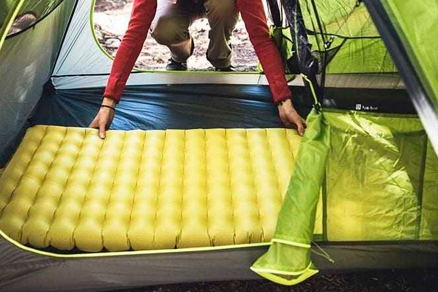 setting up sleeping pad in tent