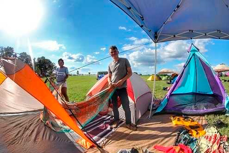 Group Of People Setting Tents