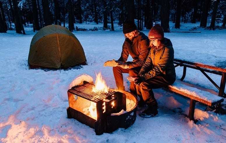 Couple Heating Next To Campfire
