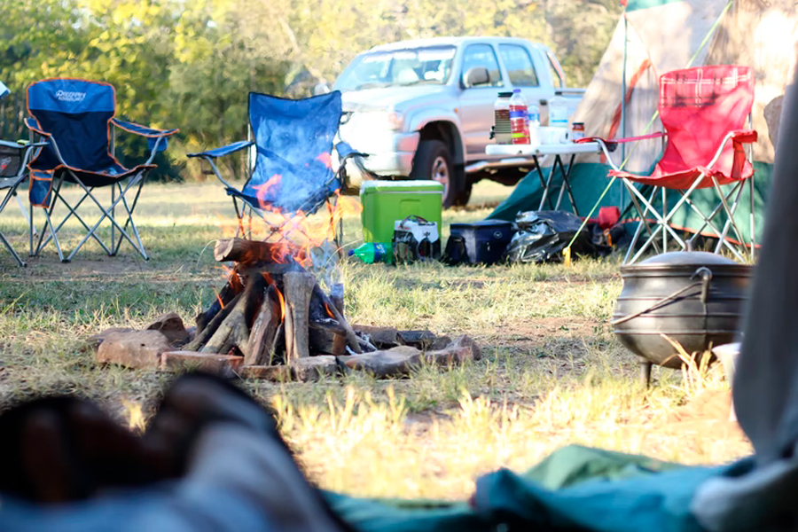 camping chairs around campfire