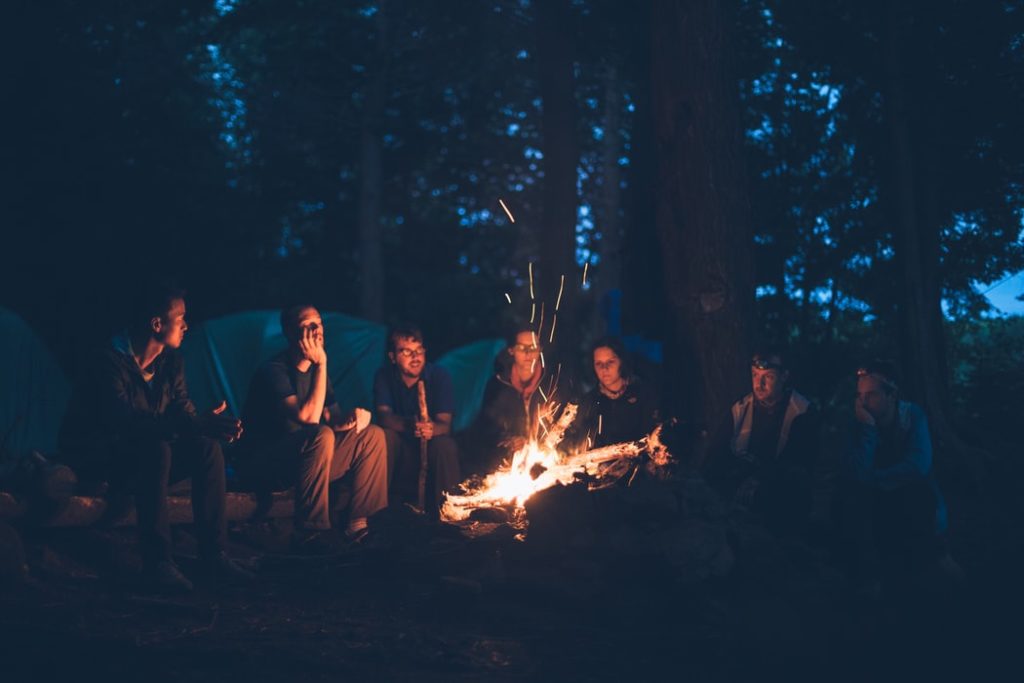 family camping by camp fire