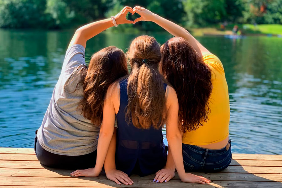 girls camping by the lake