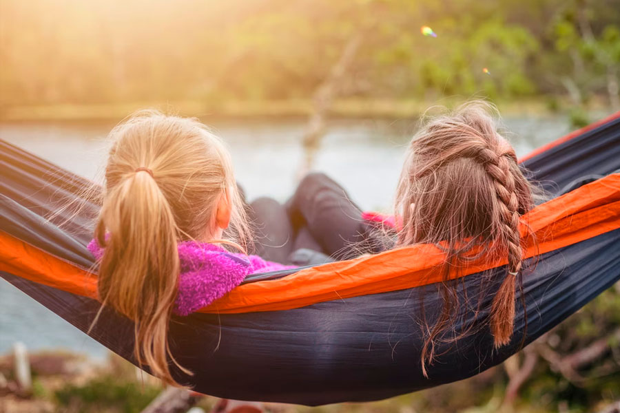 girls sitting in hammock