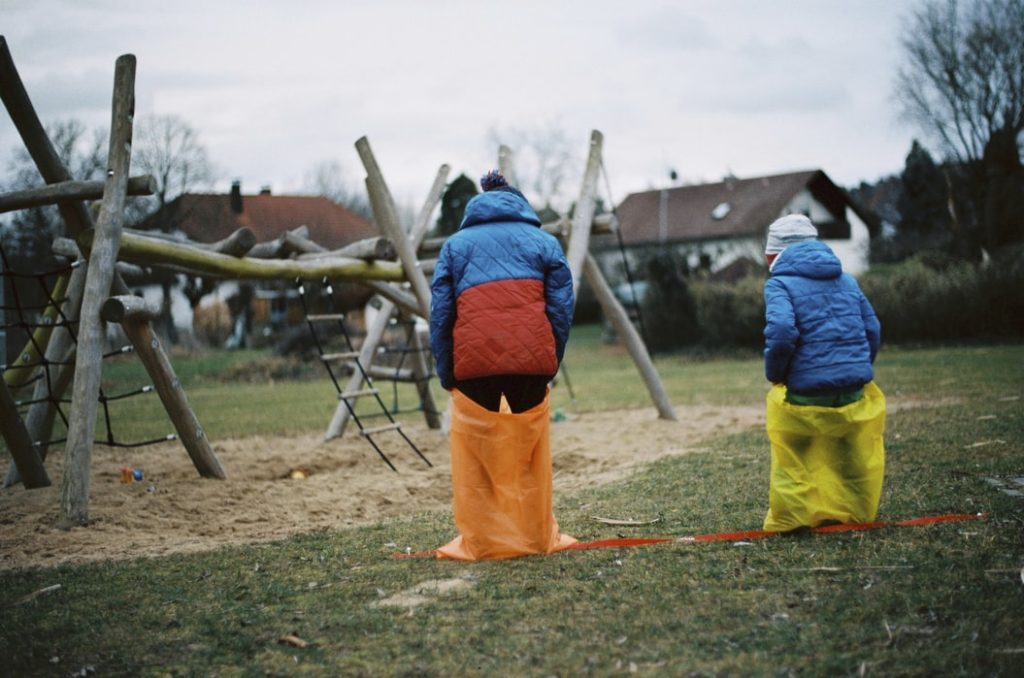 kids playing sack run on picnic party